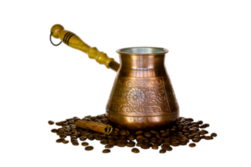 Copper coffee pot and scattered coffee beans.