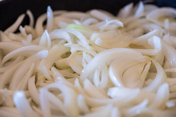 the preparation and cooking process of onions, highlighting various techniques and states, such as...
