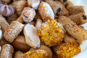 A delightful assortment of colorful and gourmet pastries, including shortbread, petits fours, and cookies, perfect for tea time or special occasions like Eid