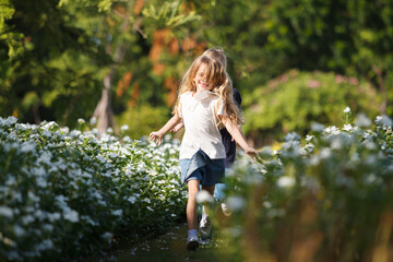 Caucasian white little girl playing at the park in morning.