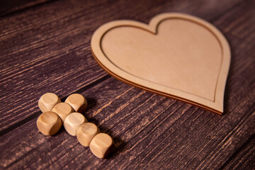 Wooden background with olive heart and white cross for an obituary notice.