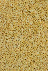 Top View of Yellow Moong Dal or Green Gram Beans Background with Copy Space in Vertical Orientation