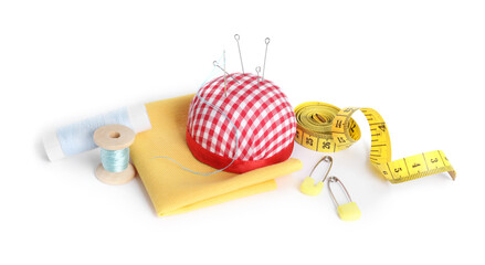 Pincushion, needles and other sewing tools isolated on white