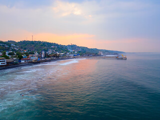 Sunset Park in Puerto de La Libertad, El Salvador beach during early morning, aerial above the water perspective.