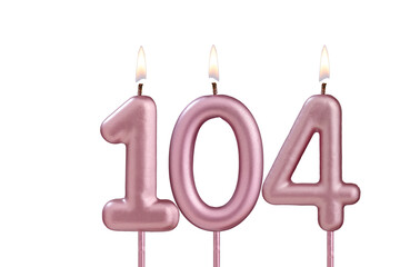 Candle number 104 - Lit birthday candle on white background