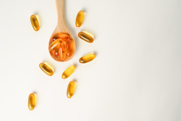 wooden spoon with soft gels, Fish oil capsules, omega 3, omega 9, vitamin D, vitamin E