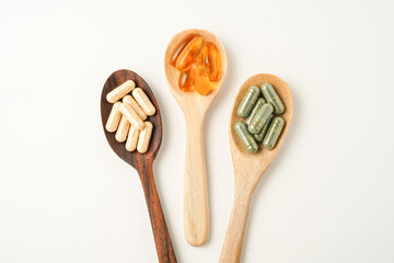 Vitamin capsules in a wooden spoon, soft gels, Fish oil capsules, omega 3, omega 9, vitamin D, vitamin E