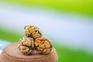 Walnut seeds closeup outdoor isolated with blurry green background, without shell