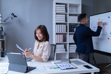 Business professionals are convening in an office setting to strategize marketing initiatives. They...