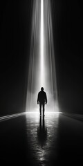 Silhouette of a man walking towards a bright, beam light. Perfect for inspirational and conceptual themes, motivational and philosophical designs, spiritual and reflective concepts