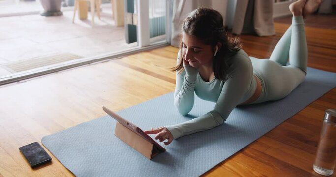 Woman, tablet and stream for fitness, tutorial and online video browse with smile. Influencer, social media and internet for yoga, pilates or workout research with exercise podcast at home or house