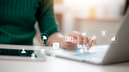 Women using laptops to fill out personal income tax returns and pay taxes online illustrate the tax concept. This process involves state tax, financial research, data analysis, and managing documents,