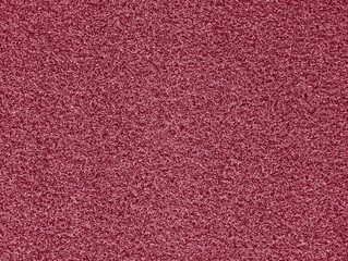 Artificial vibrant pink grass doormat or rug for outdoor exterior home entrance texture or background. Decorative fake turf lawn front door mat outside house. 