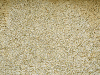 Light yellow rough cement concrete exterior wall texture or background.