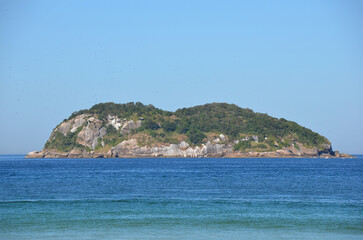 Naklejka premium Wide view of Alfavaca island from the viewpoint at Praia da Barra da Tijuca, a paradise in Rio de Janeiro, Brazil.