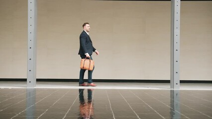 Side view of business people holding suitcase and walking to workplace along the street in urban city. Professional project manager going to meeting while wearing formal suit walk at outdoor. Urbane.