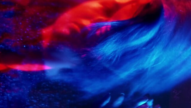 Vertical video. Split mind. Defocused silhouette. Neon red blue light woman mental fear barrier trap shiny reflection double exposure out of focus.