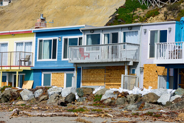 Beachfront houses at Rio Del Mar Beach strewn with storm debris. The front row of coastal home...