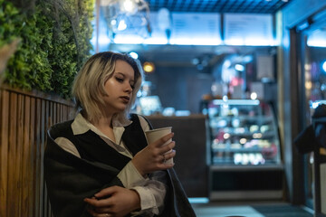 Portrait of a young beautiful blonde girl in an evening spring city.