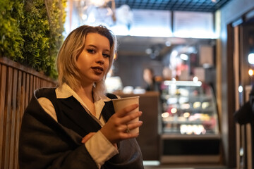 Portrait of a young beautiful blonde girl in an evening spring city.