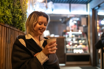 Portrait of a young beautiful blonde girl in an evening spring city.
