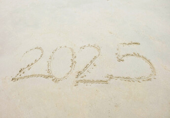 Sand floor with numbers written on it, New Year 2025.