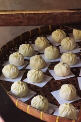Steamed bun stuffed with minced pork on bamboo basket, Asian food