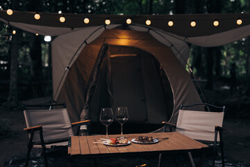 2 Wine glasses in camping nature at twilight.