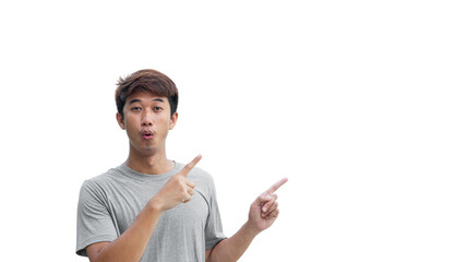 A young Asian man in his 20s wearing a gray t-shirt happy shocked face pointing thumbs up isolated on a white background. The person's index finger pointing to a blank space for text