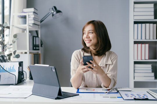 Young Professional Woman Working from Home Office with Digital Devices and Documents