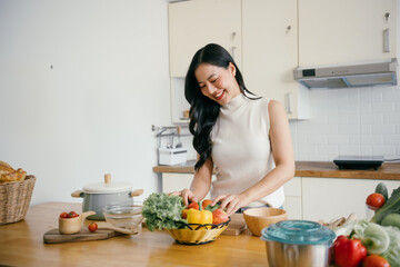 Young Woman Preparing Fresh Vegetables in a Modern Kitchen with a Bright and Cheerful Atmosphere