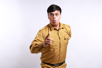 Serious face of male with khaki uniform pointing to camera isolated over white background
