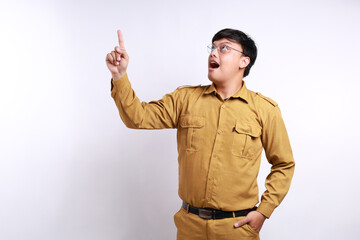 Indonesia government worker with brown uniform pointing to copy space isolated