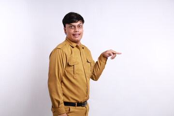 Side view indonesian civil servant standing while pointing finger to the side