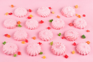 Pink marshmallows and Candied colorful fruits bits. Pink background,Top view