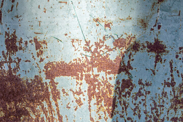 Metal sheet painted with gray color with rust. Empty deformed metal wall texture background. Distorted grunge gray metal sheet with rust. Empty gray background for minimal style designs.