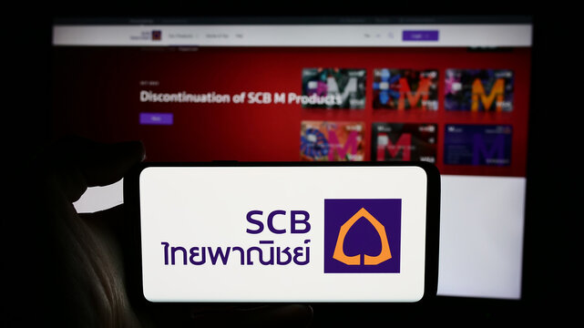 Stuttgart, Germany - 06-07-2024: Person holding cellphone with logo of The Siam Commercial Bank Public Company Limited (SCB) in front of business webpage. Focus on phone display.