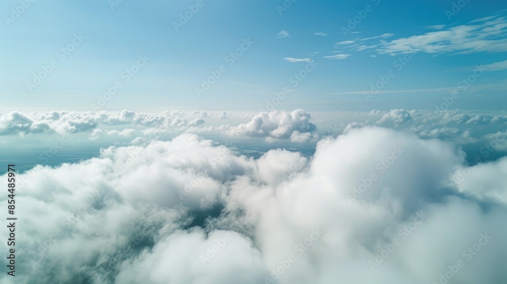 Wall mural Beautiful aerial view of nature with white clouds and blue sky captured from a drone on a sunny day from high altitude in the front perspective