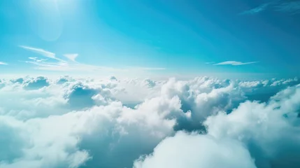 Beautiful aerial view of nature with white clouds and blue sky captured from a drone on a sunny day from high altitude in the front perspective © CreativeBro