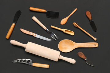 Set of wooden kitchen utensils on black background