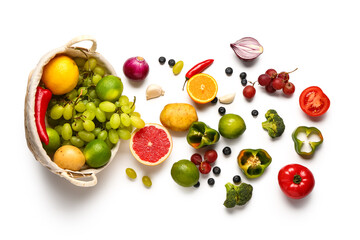 Wicker basket with different fresh fruits and vegetables on white background