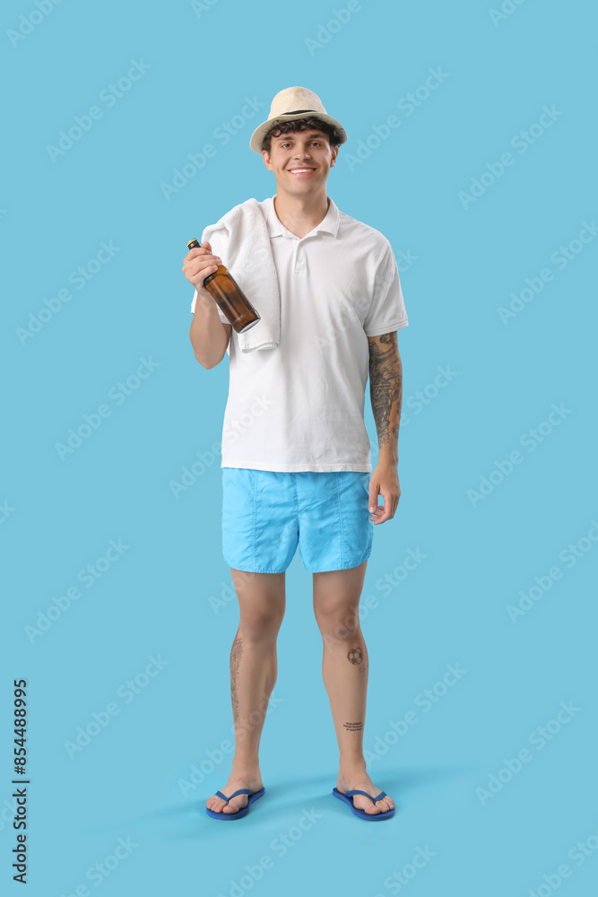 Sticker Young man with bottle of beer on blue background