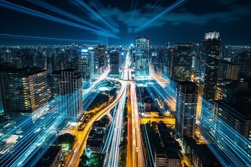 Fototapeta premium Aerial top view of car driving in vibrant and bustling urban megalopolis at night