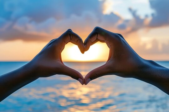 Two hands that are making a heart shape adult sea tranquility.