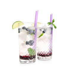 Glasses of fresh blueberry lemonade with mint on white background