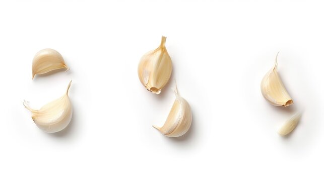Three garlic pieces isolated on a white background from a top down perspective separated food or cooking elements