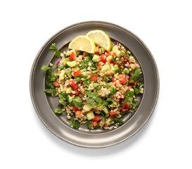 Plate with delicious tabbouleh salad and lemon slices on white background