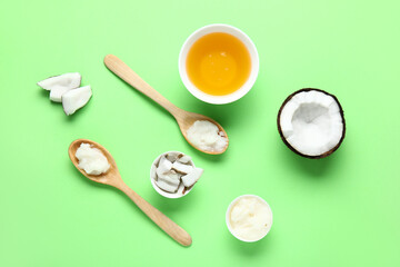 Bowls and spoons of coconut cosmetic oil on green background