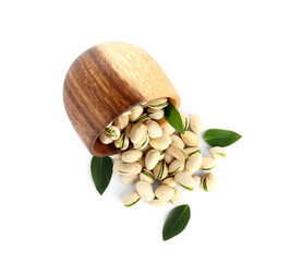 Wooden bowl with tasty pistachio nuts and leaves on white background
