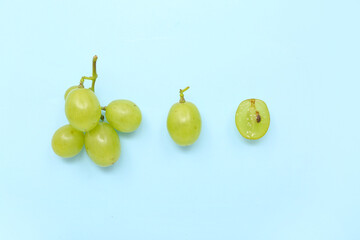 Sweet green grapes on blue background